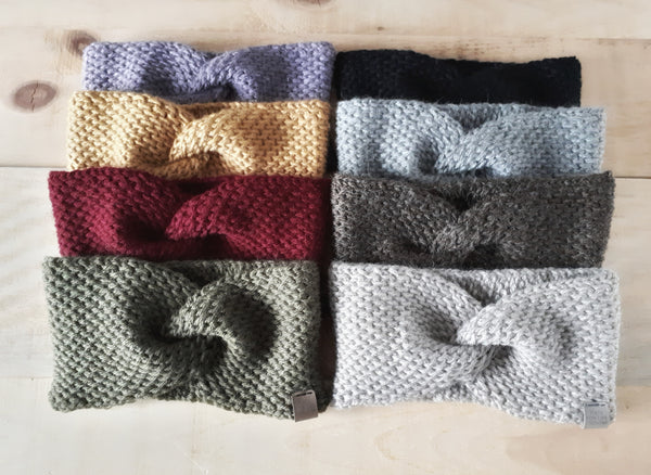 collection of all tunisian headbands laid against barnwood background. 